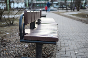 Photo bench on the background of the cityscape on a spring day