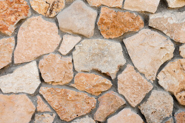 Decorative wall made of natural stone of various shapes and sizes. Interior background