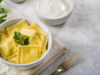 Homemade ravioli or dumplings with sauce on a light background. Recipes