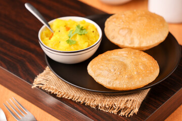 Puri Bhaji North Indian Poori with aalu bhaji , aalu sabji potato spicy recipe breakfast food a deep fried bread of whole wheat flour. poori masala in restaurant Kerala, India, Sri Lanka.
