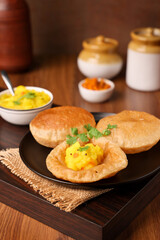 Puri Bhaji North Indian Poori with aalu bhaji , aalu sabji potato spicy recipe breakfast food a deep fried bread of whole wheat flour. poori masala in restaurant Kerala, India, Sri Lanka.
