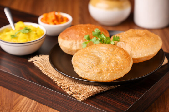 Puri Bhaji North Indian Poori with aalu bhaji , aalu sabji potato spicy recipe breakfast food a deep fried bread of whole wheat flour. poori masala in restaurant Kerala, India, Sri Lanka.