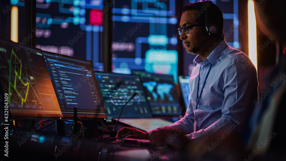 Aufkleber Professional IT Technical Support Specialist and Software Developer Working on Computer in Monitoring Control Room with Digital Screens. Employee Uses Headphones with Mic, Talking on a Call.