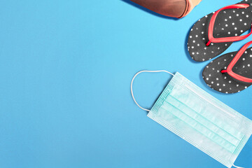 Slipper and face mask on a colored background