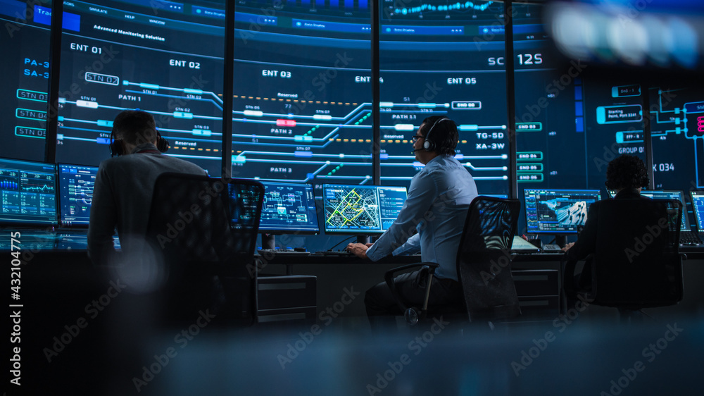 Aufkleber Professional IT Technical Support Specialist and Software Developer Working on Computer in Monitoring Control Room with Digital Screens. Employee Uses Headphones with Mic and Talking on a Call.