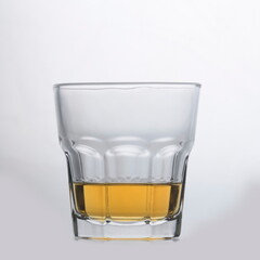 Whiskey in the glass on smooth surface