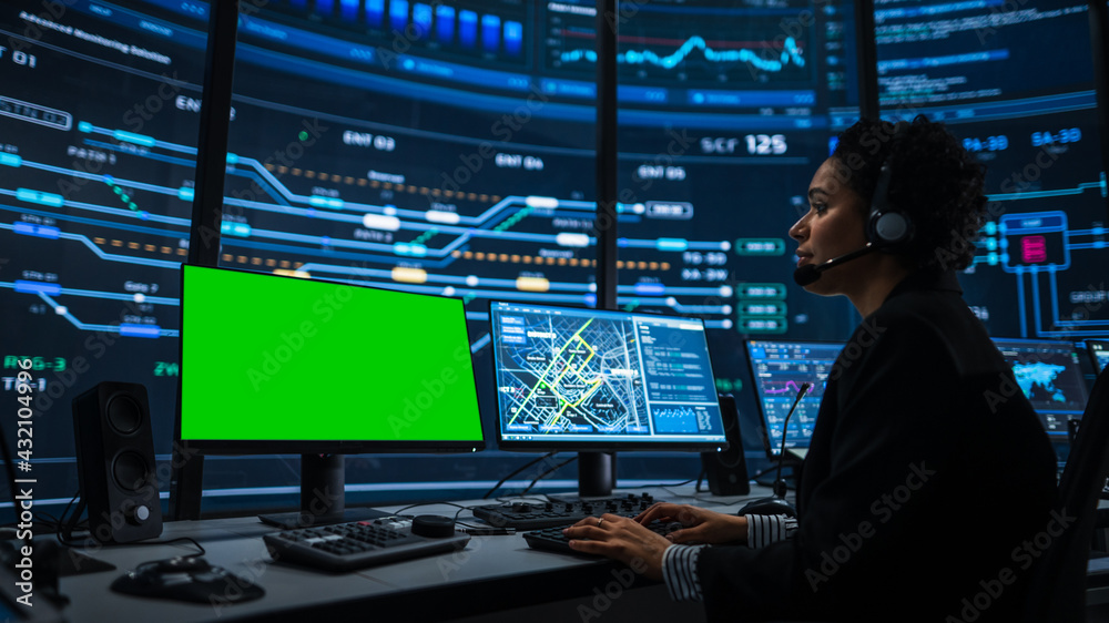 Poster Professional IT Technical Support Specialist and Software Developer Working on Computer with Green Screen Mock Up Display in Monitoring Control Room with Digital Screens. Female Wears Headphones.