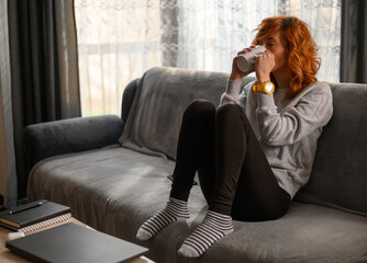Woman drinking coffee in the morning at home