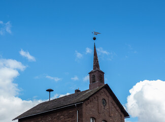 Old church and striking clock in sunshine in Germany