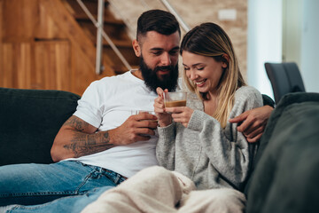 Romantic couple drinking coffee at home