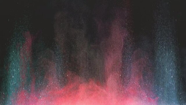 The colorful explosion of shimmering particles. slow motion
