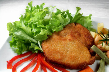 Plate with Milanese cutlet, mixed salad and artichokes 