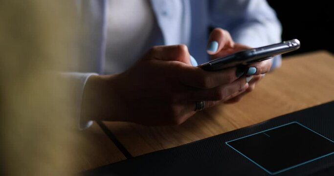 Anonymous Businesswoman holding in hands smartphone, typing text message via cell phone, charging in mobile phone, using modern device, freelancer woman working at home or office