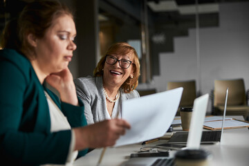 Chief company officer laughing at her upset employee