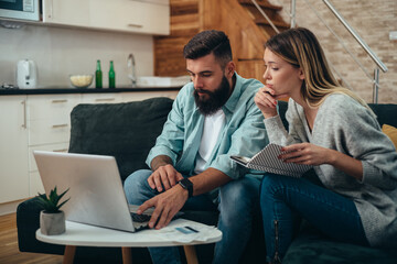 Young beautiful couple using a laptop