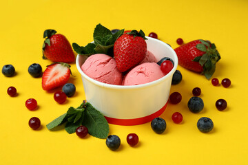 Fruit ice cream and ingredients on yellow background