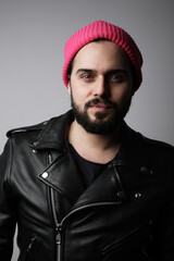 Obraz premium Vertical portrait of young handsome bearded man, wearing pink hat. Isolated.