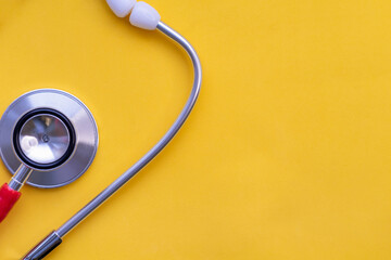 National Science Day. Stethoscope on a yellow background, doctor's tool. The concept of medicine,...