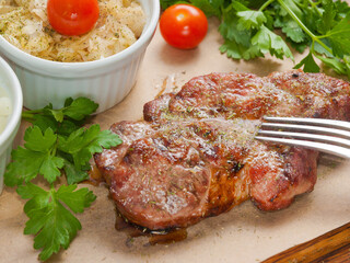 juicy pork neck steak with cabbage appetizer. Selected focus.