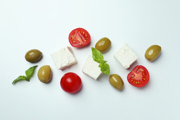 Feta, olives, tomato and basil on white background