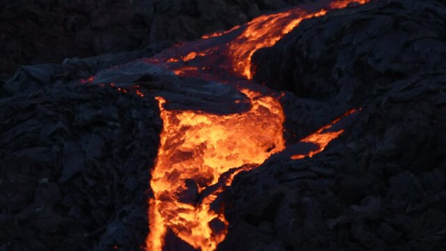 Hot Lava Stream Flowing During Volcanic Eruption Of Fagradalsfjall In Geldingadalir, Iceland - aerial shot