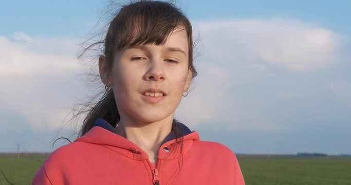 Allergy in nature. A smiling little girl cough because of seasonal allergy in the summer field in the day light.