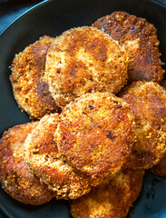 Juicy homemade cutlets on a black plate