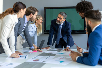 Business colleagues in conference meeting room during presentation