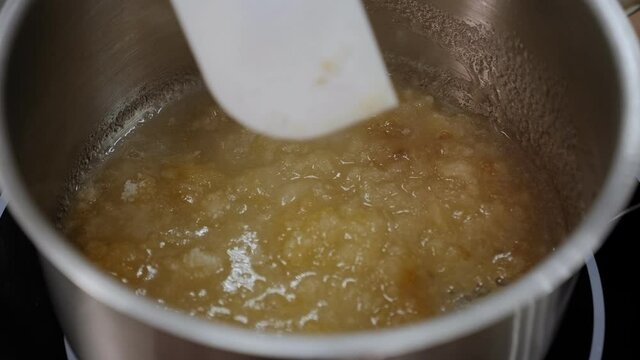 Close-up of the process of preparing caramel, caramel boils in a pan.