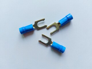 Close up of insulated cable lugs with white background.