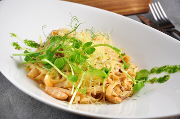 pasta with chicken and bacon on a white plate