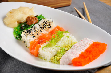 beautiful layered poke with salmon on a white plate