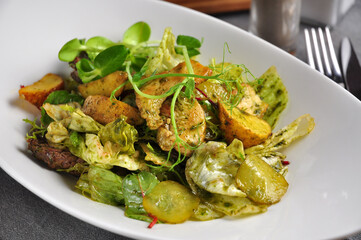 warm salad with beef, chicken, pork and vegetables
