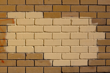 brown brick wall, part of the wall painted beige