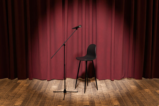 microphone and stool on a stage with curtains behind