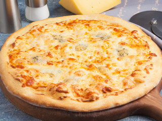 pizza four cheeses on a wooden Board