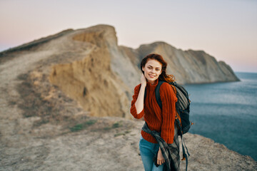 Traveler with backpack mountains sunset sea ocean model