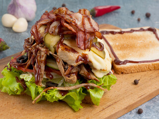 sandwich or toast with chicken beef bacon and barbecue sauce