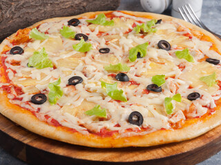 Hawaiian pizza with chicken pineapple and olives