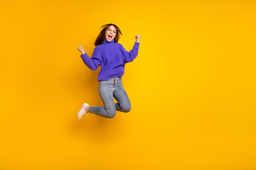 Fototapeta na wymiar Full length body size view of attractive cheerful lucky girl jumping having fun rejoicing isolated over bright yellow color background
