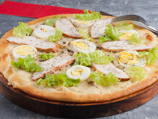 Caesar pizza with smoked chicken breast chicken egg and mushrooms