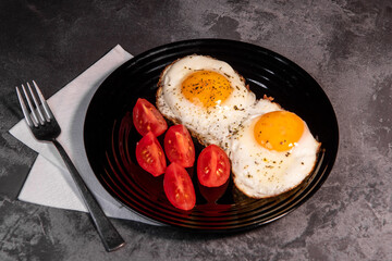 fried eggs and tomato slices, delicious breakfast, snack, yolk and protein food, background, top view, copy space, eat healthy raw materials. Scrambled eggs. Breakfast. Healthy eating. Close-up