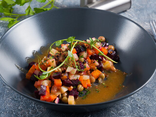 vinaigrette in a dark plate. Vegetarian food. Healthy diet