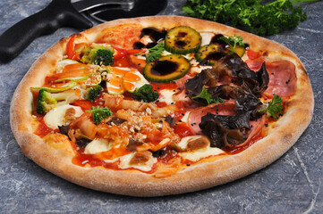 Asian pizza with chicken, ham, zucchini, bell pepper, shiitake mushrooms, hot cabbage, broccoli