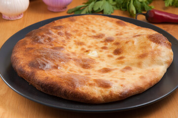 traditional Georgian cuisine. Imereti khachapuri on a dark plate
