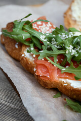 Croissant with trout and arugula. Macro.