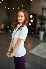 Fototapeta premium The girl in a white robe. Beautiful girl doctor in the office.