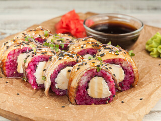 Philadelphia sushi rolls with eel. New: beetroot rice