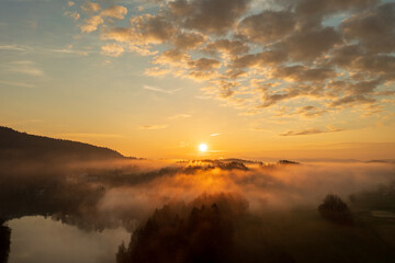 magical sunrise with fog in the Bavarian forest drone panorama