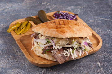 Turkish Doner with chicken cheese and onion on a wooden plate